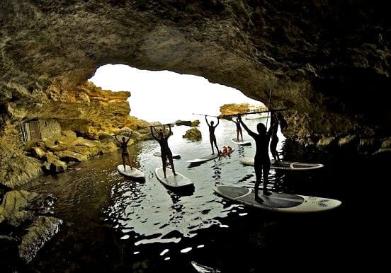 stand up paddle through coastal caves in Ibiz stand up paddle through coastal caves in Ibiza