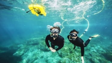 Couple scuba snorkel in Lobos island Couple enjoying underwater scuba snorkel in Lobos island